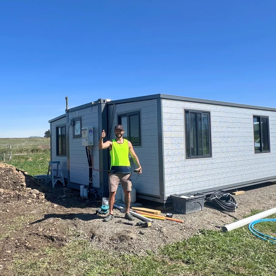 Expanders® installer on site with a completed expandable home