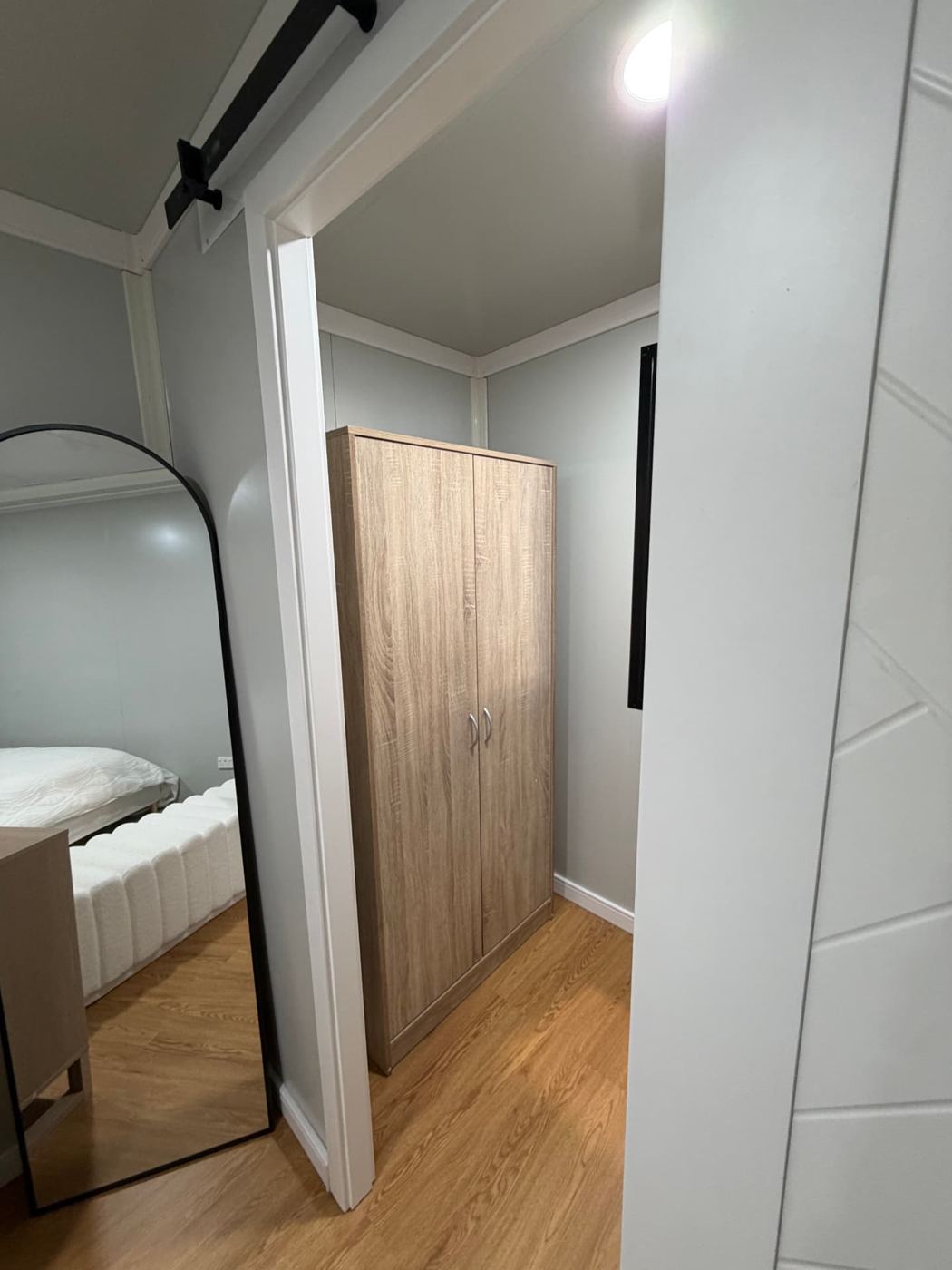 Walk-in wardrobe with full-height timber-look cabinetry