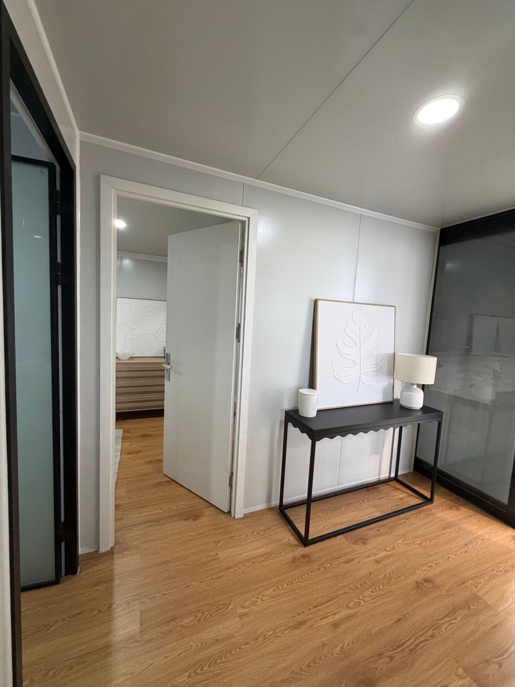 Entry hallway with console table leading to the bedroom and bathroom