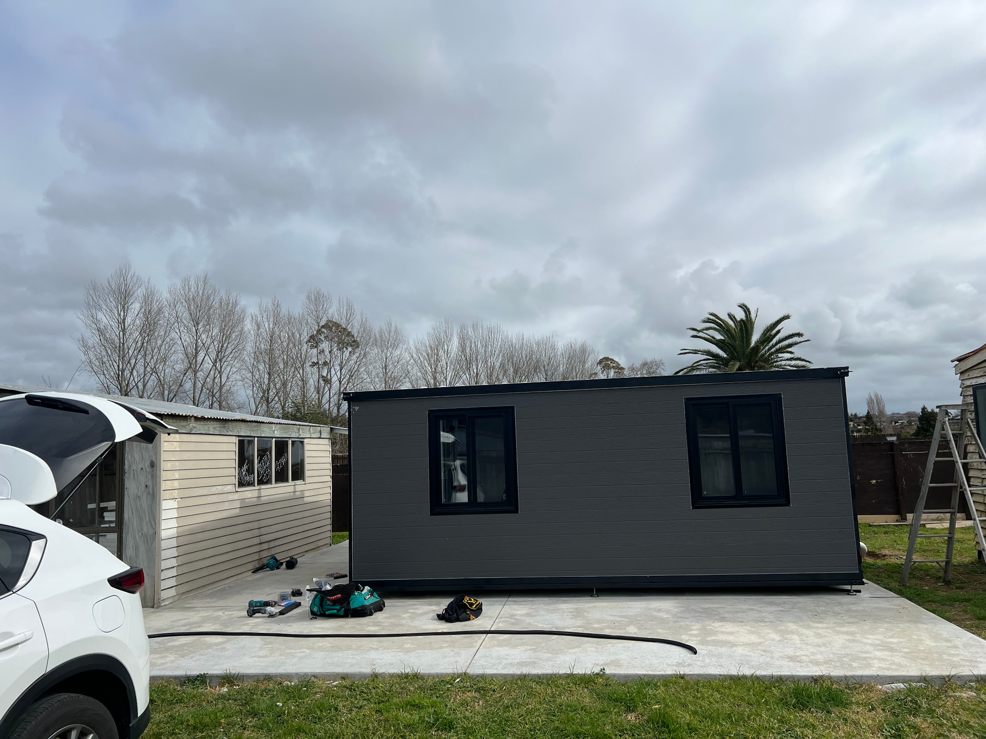 Dark grey 20ft Expander® in a driveway